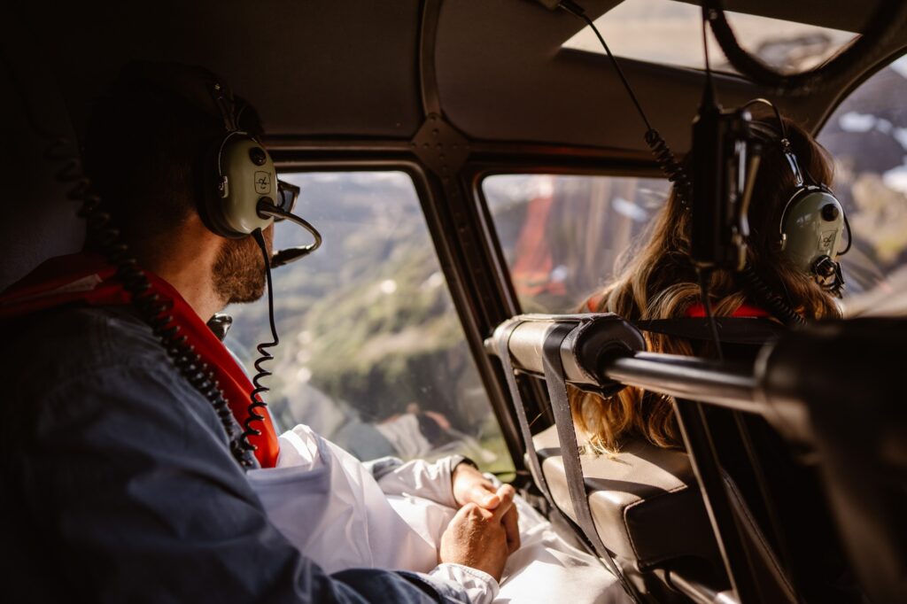 Couple flying by helicopter to their adventure elopement in Alaska