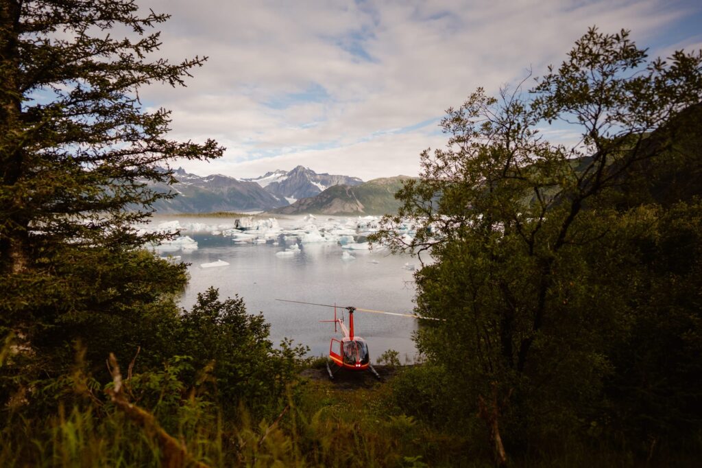 View of helicopter on the shore of a glacial lagoon in Alaska