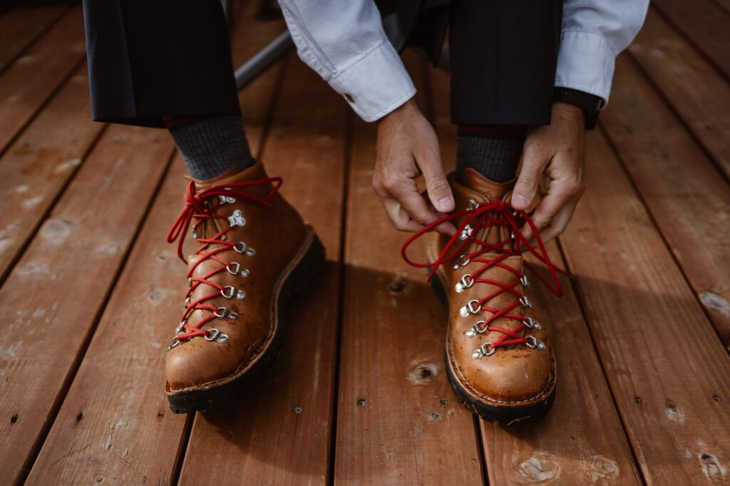 Groom lacing up Danner hiking boots