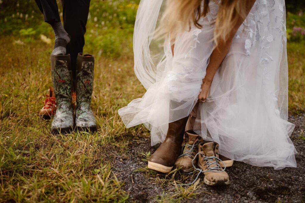 Bride and groom putting on waterproof boots to go explore