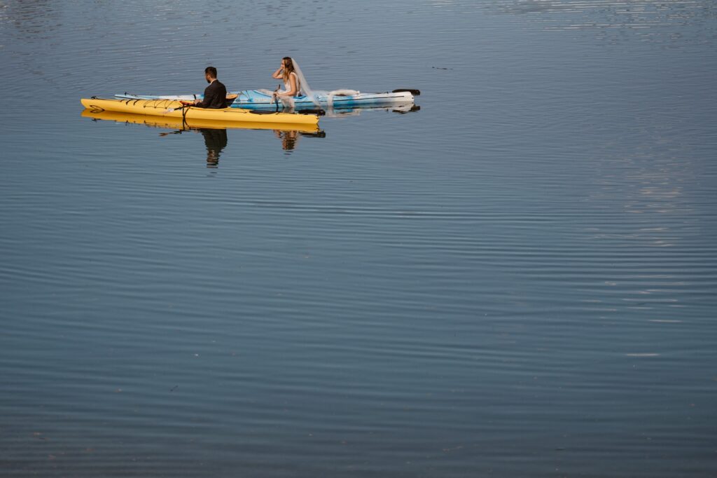 Bride and groom on sea kayaks
