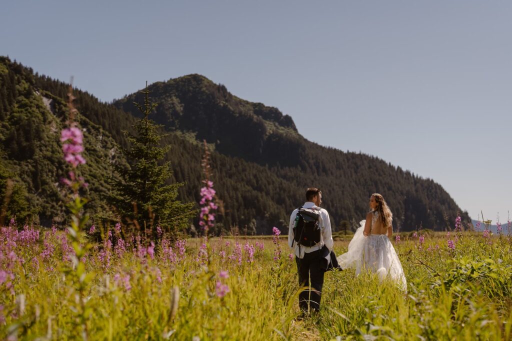 Couple hiking through a meadow of wildflowers