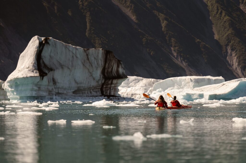 Couple kayaking in dry suits on their elopement day in Alaska