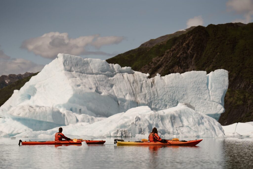 Kayaking by a massive iceberg in Alaska