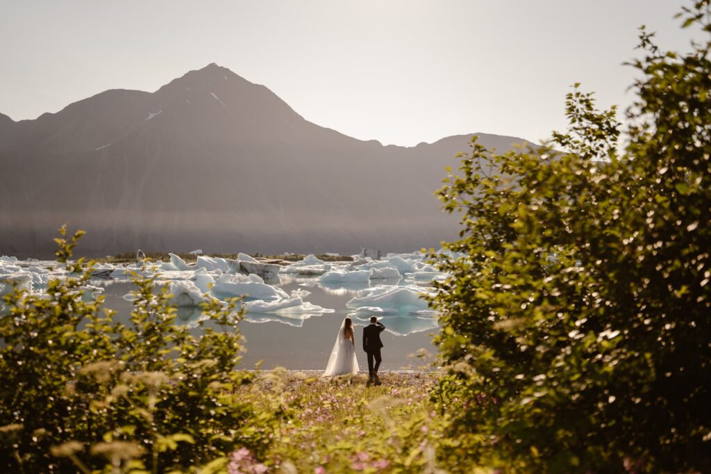 Couple picking their elopement ceremony spot on the shore of a glacial lagoon