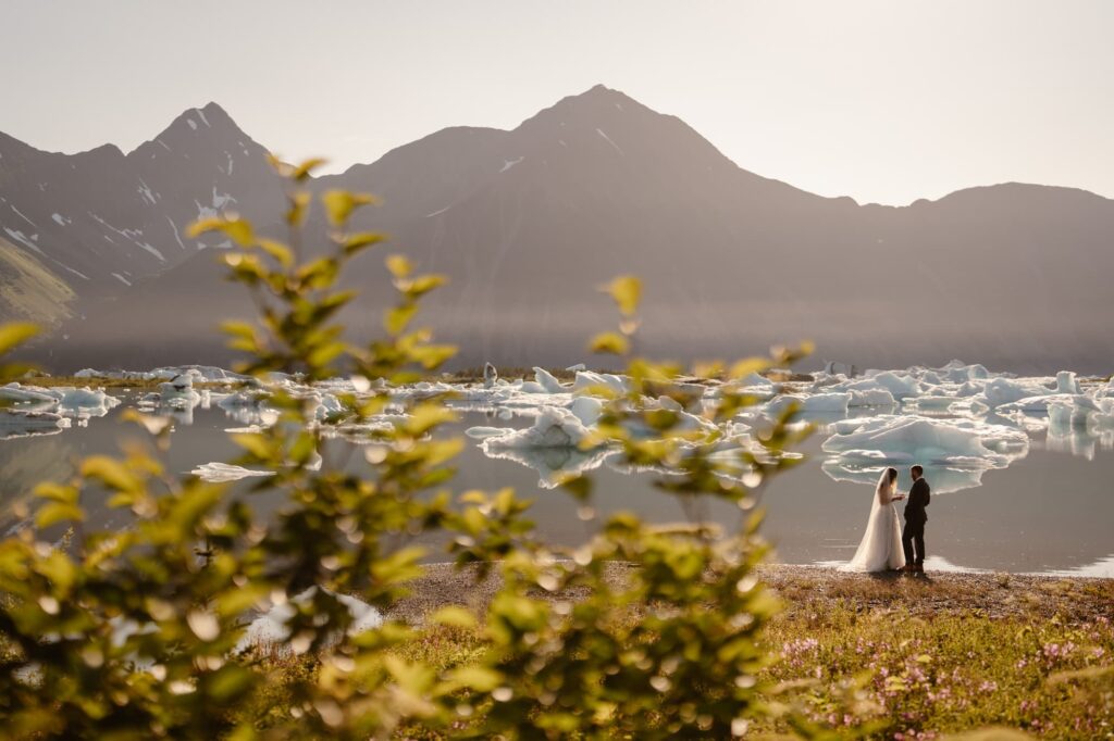 Couple exchanging vows at sunset at Bear Glacier