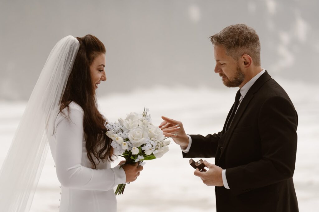 Ring exchange during elopement ceremony at Bear Lake
