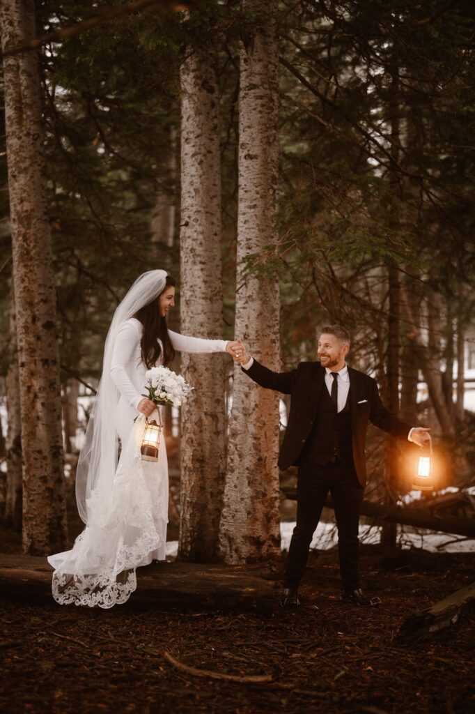 Bride walking down a log with lanterns