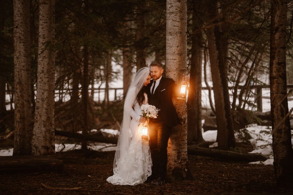 Couple in the forest with glowing lanterns