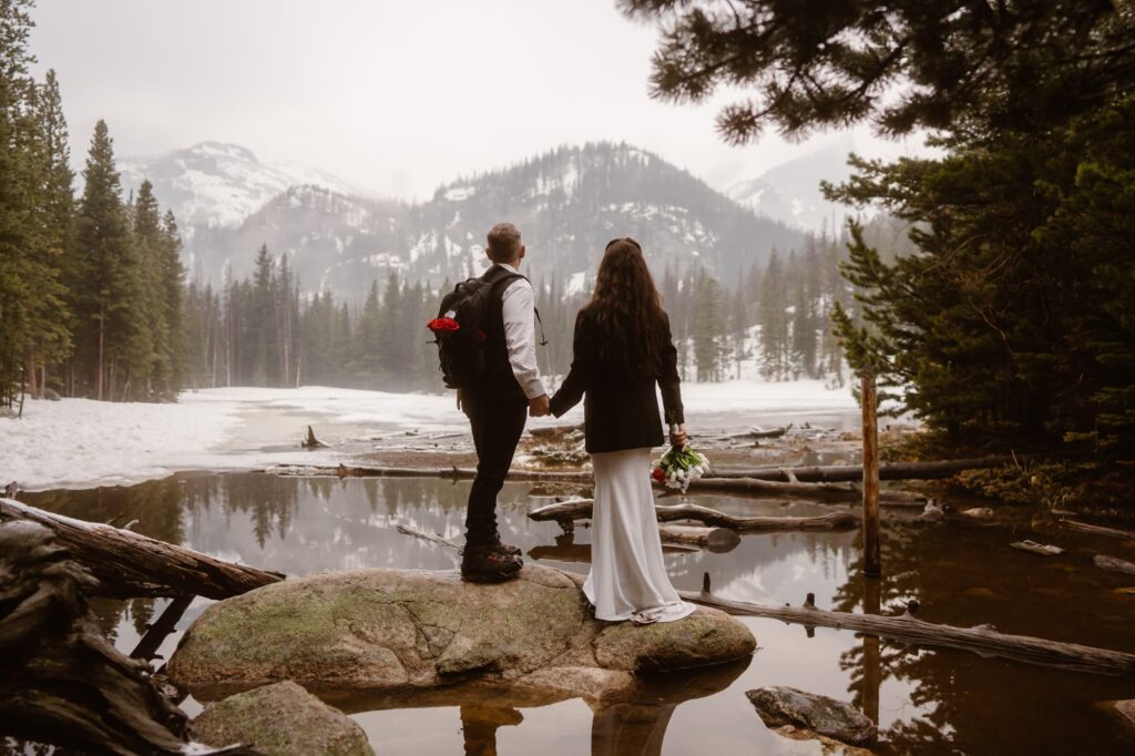 Couple standing on the shore of alpine lake in Colorado