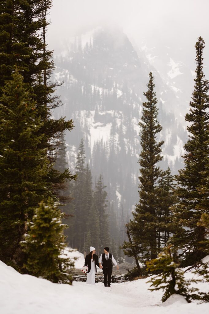 Bride and groom hiking at Dream Lake