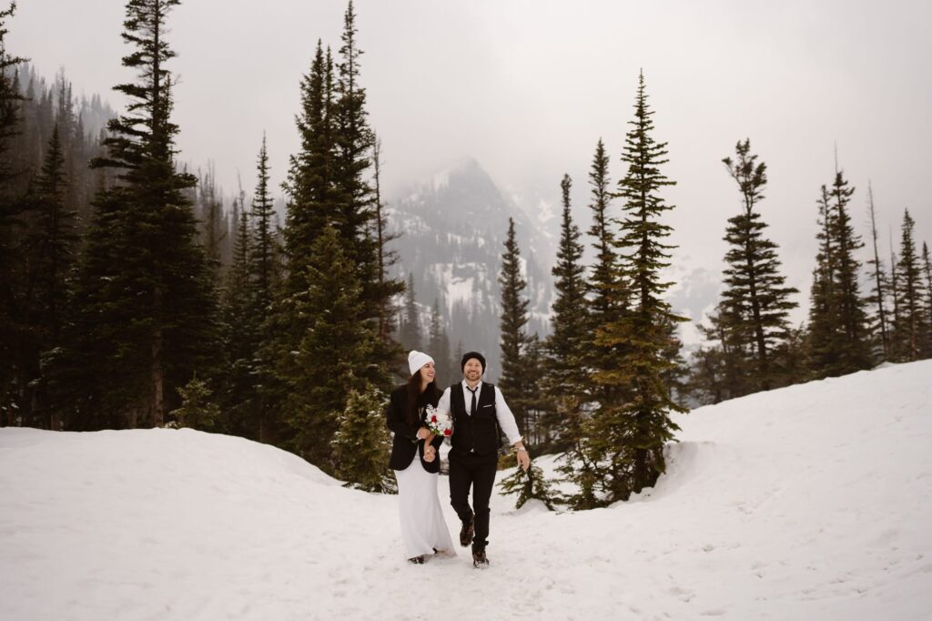 Bride and groom leaving Dream Lake and hiking back to the trailhead