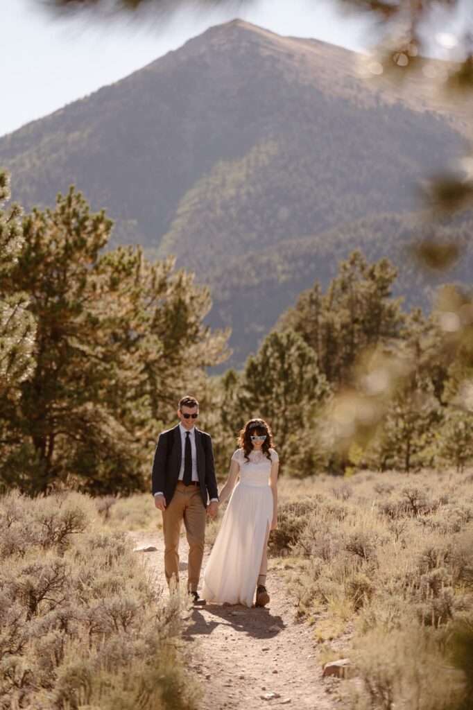 Couple in the mountains hiking during their adventure elopement