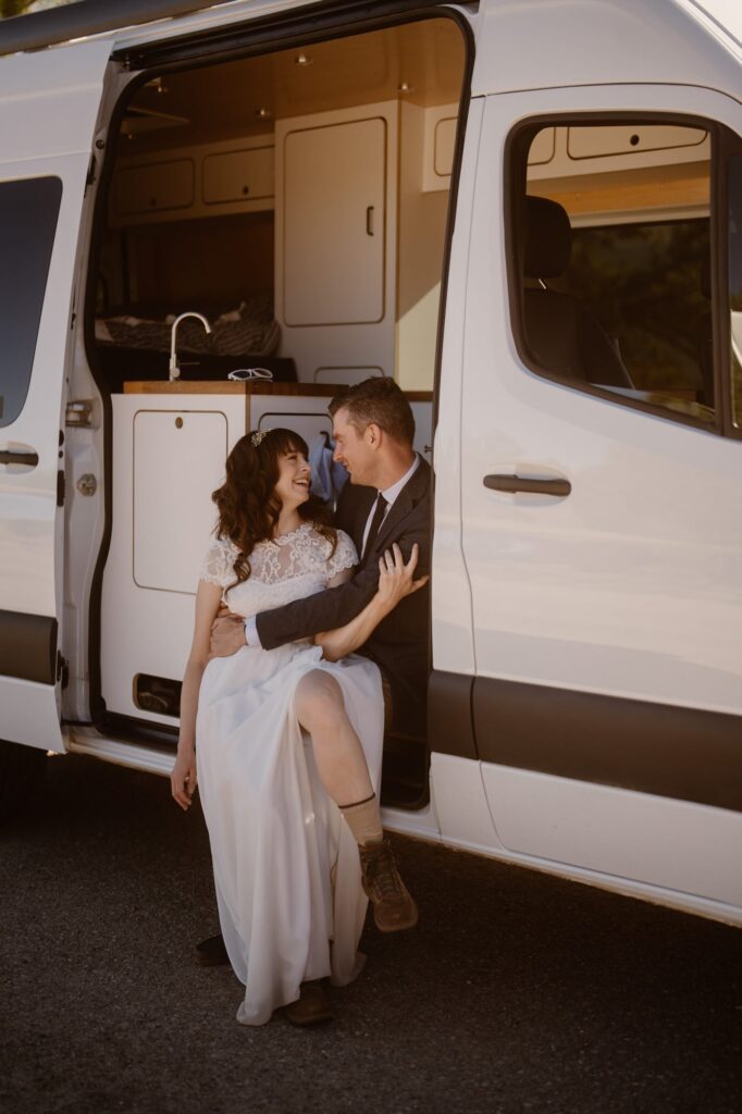 Couple sitting in their camper van on their elopement day