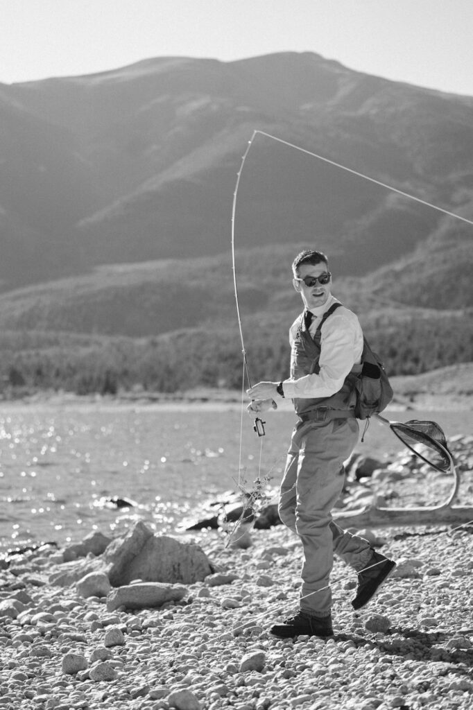 Groom fly fishing on his elopement day