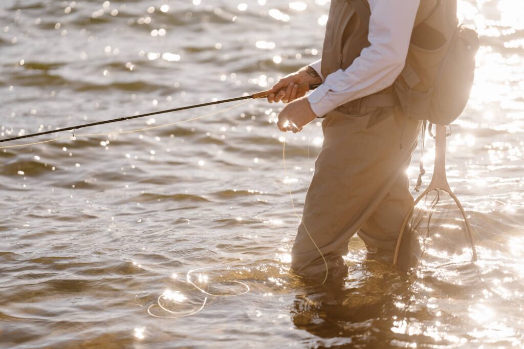 Fly fishing during Colorado adventure elopement