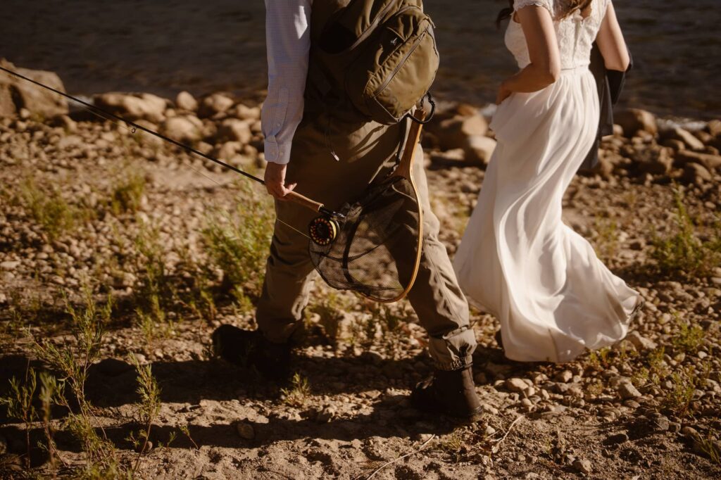 Couple fly fishing at their elopement
