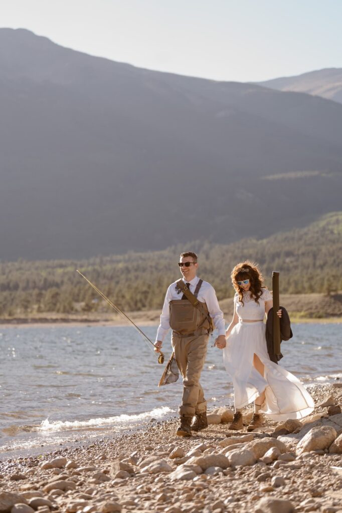 Couple walking the shore of the lake and fly fishing