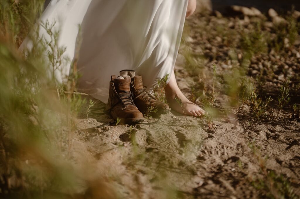 Barefoot bride with hiking boots