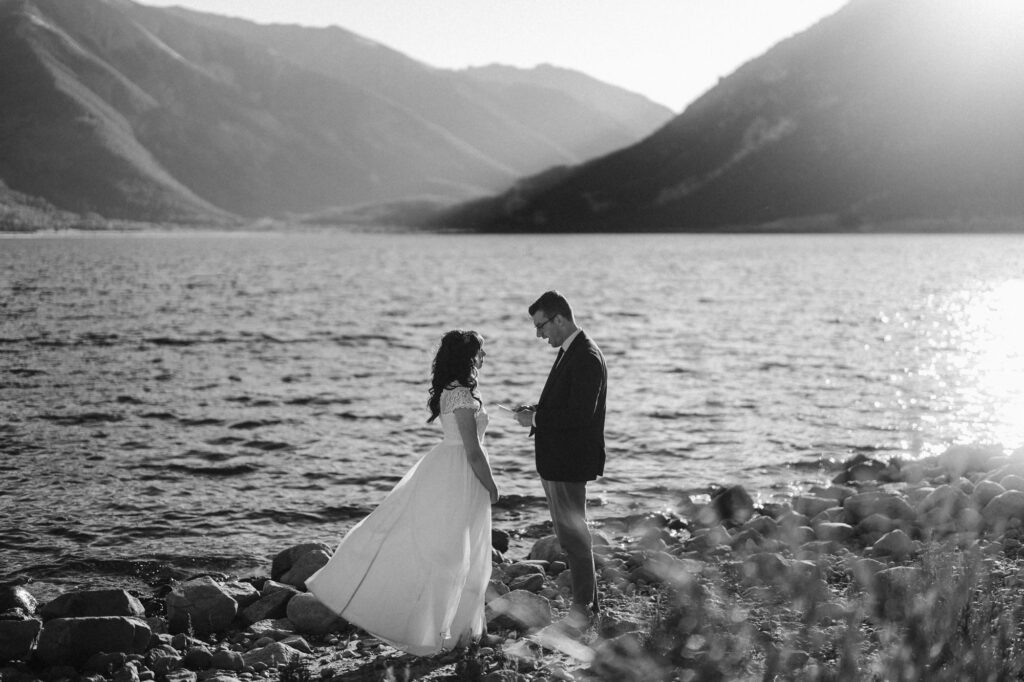Couple getting married on a lake as the sun sets