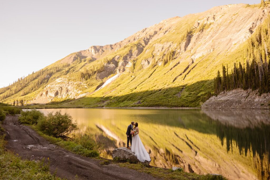 Couple kissing at an alpine lake in Crested Butte, Colorado