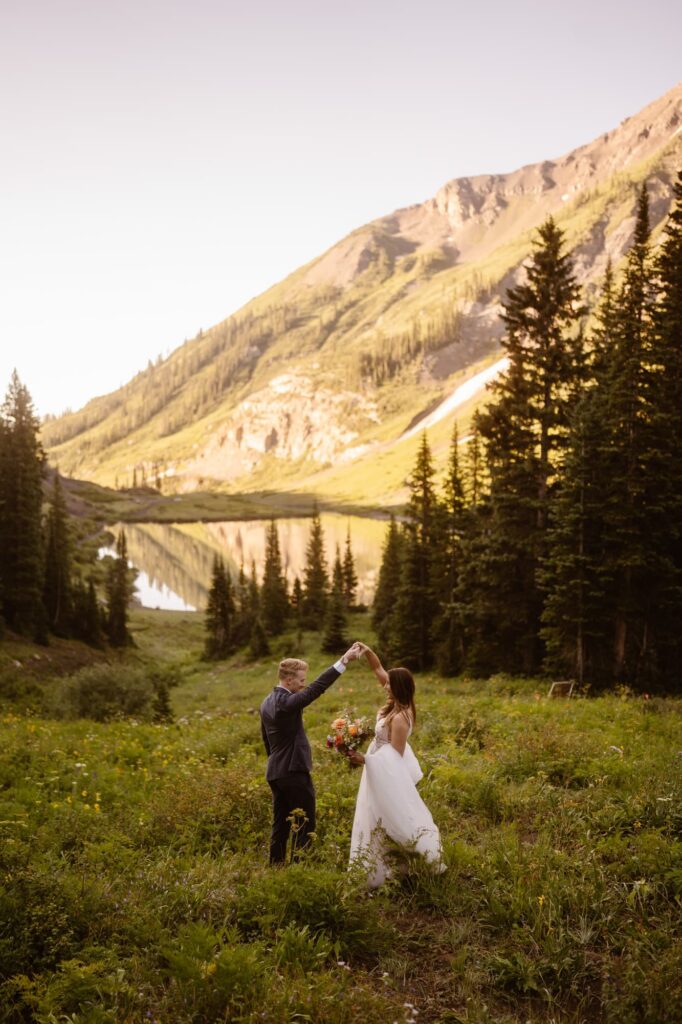 Wedding couple dancing in Crested Butte at an alpine lake