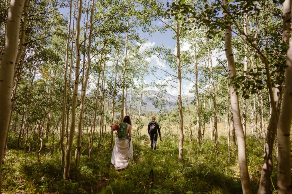Couple hiking through an aspen grove in Crested Butte