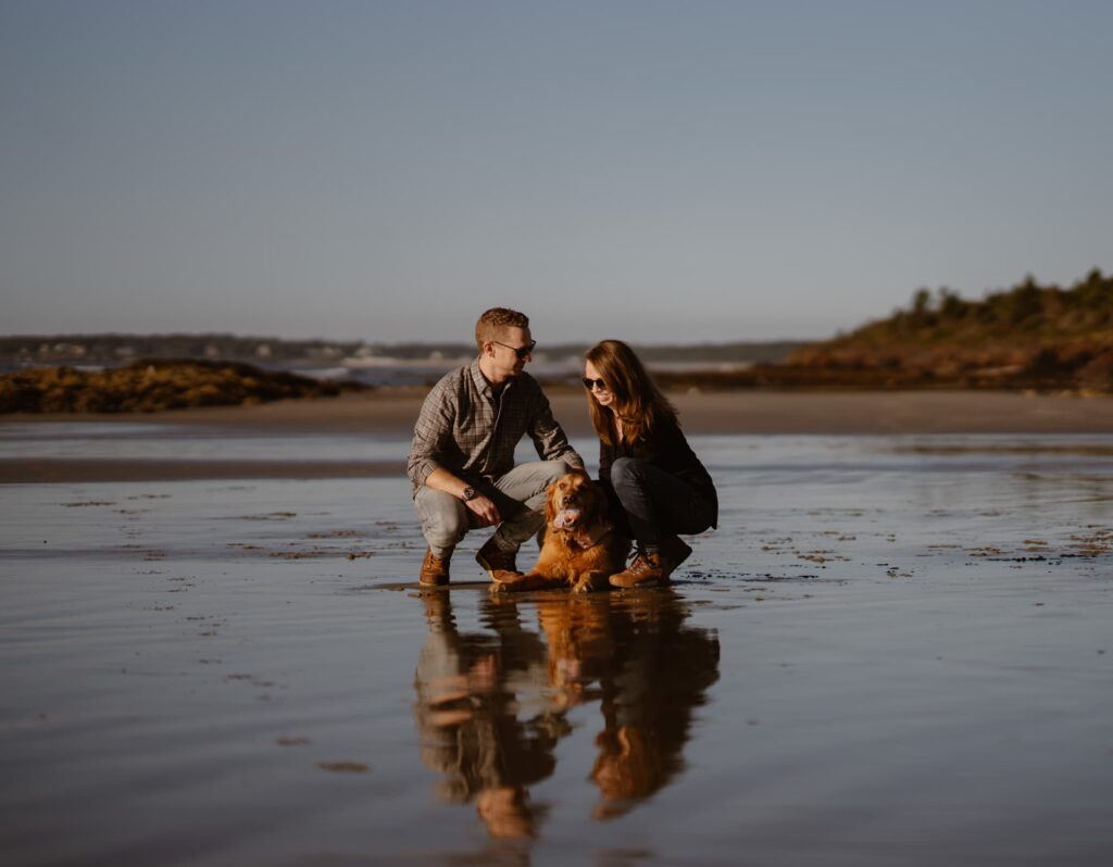 Couple with their dog on a beach in Maine