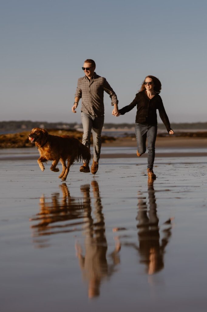 Couple on a dog-friendly beach near Portland, Maine