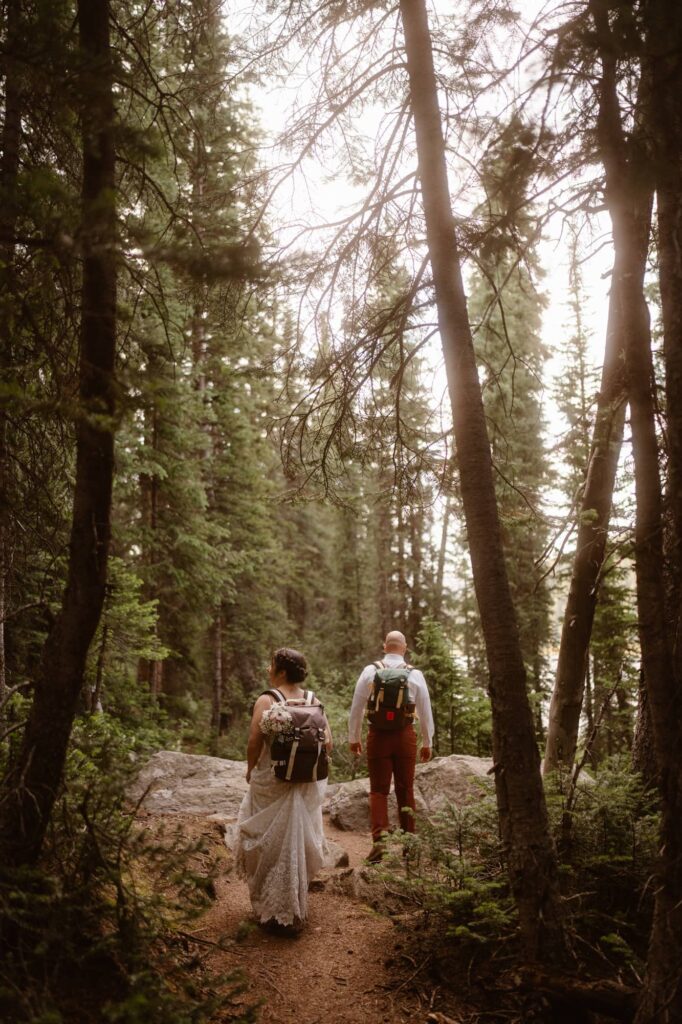 Walking off into the glowing forest on their elopement day