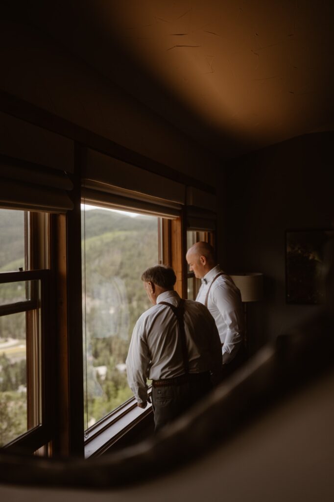 Groom and father of the bride looking out the window