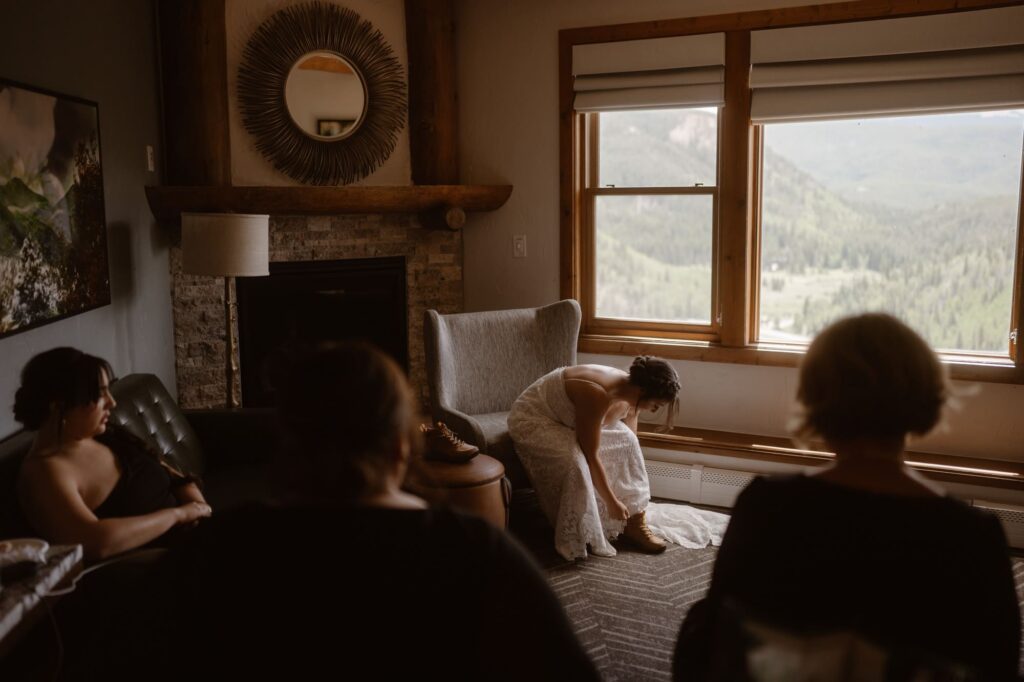 Bride putting on her hiking boots before her Breckenridge elopement