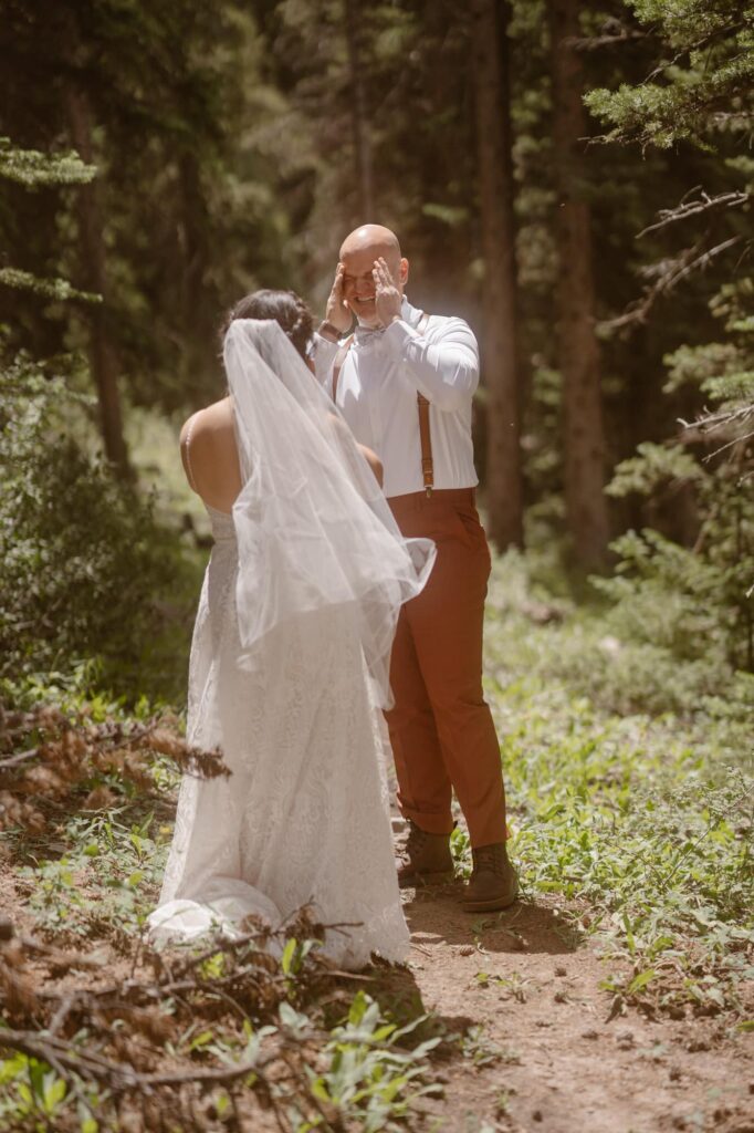 Groom thrilled to see his bride for the first time on their elopement day in Breckenridge, Colorado