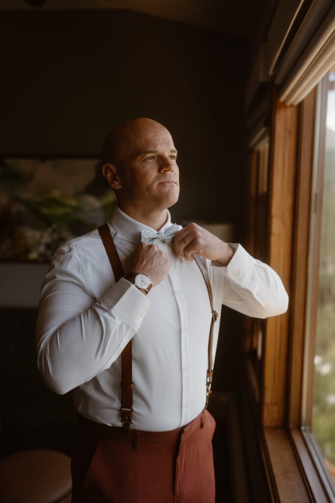 Groom checking his bow tie
