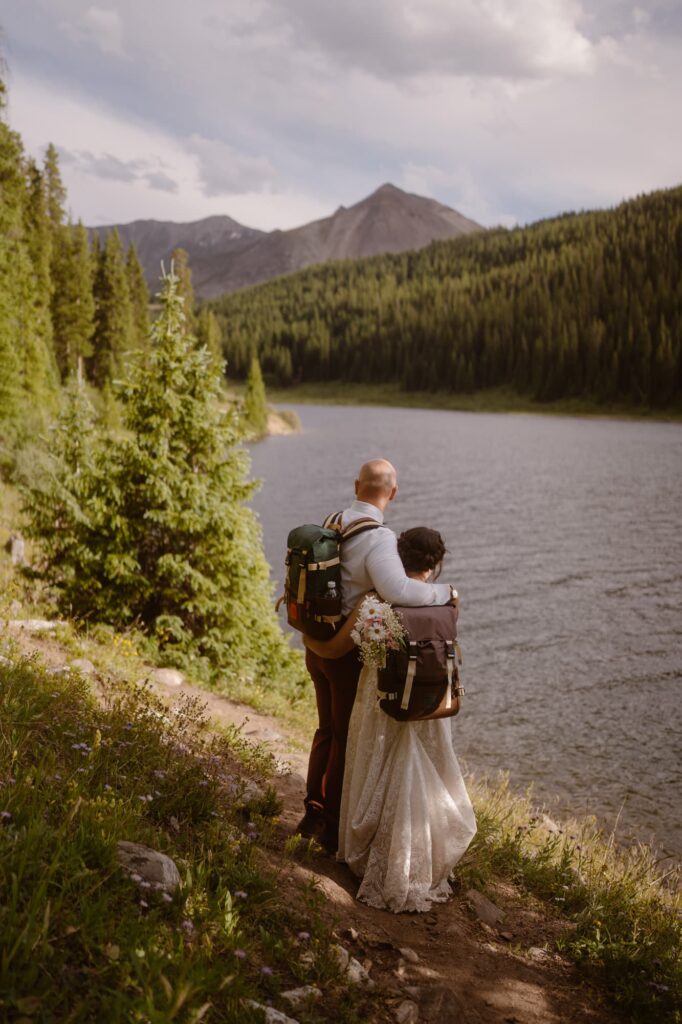 Bride and groom in backpacks during their Breckenridge, Colorado elopement