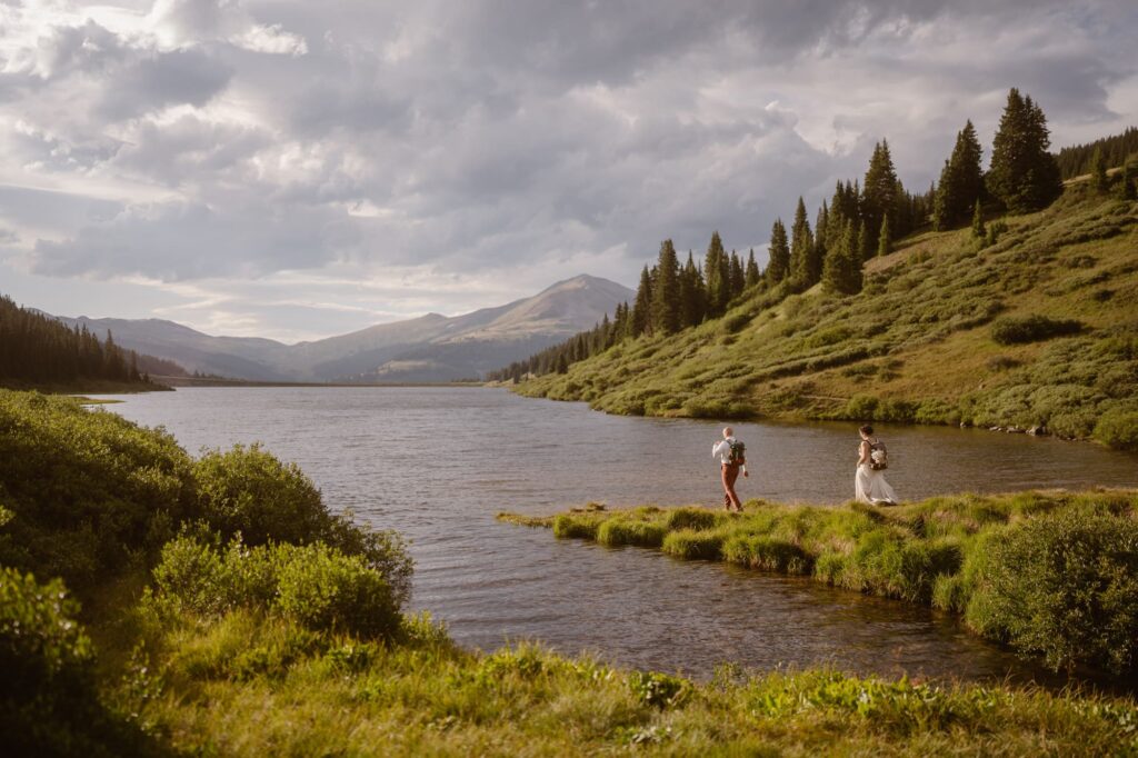 Couple walking down a peninsula at a lake in Colorado