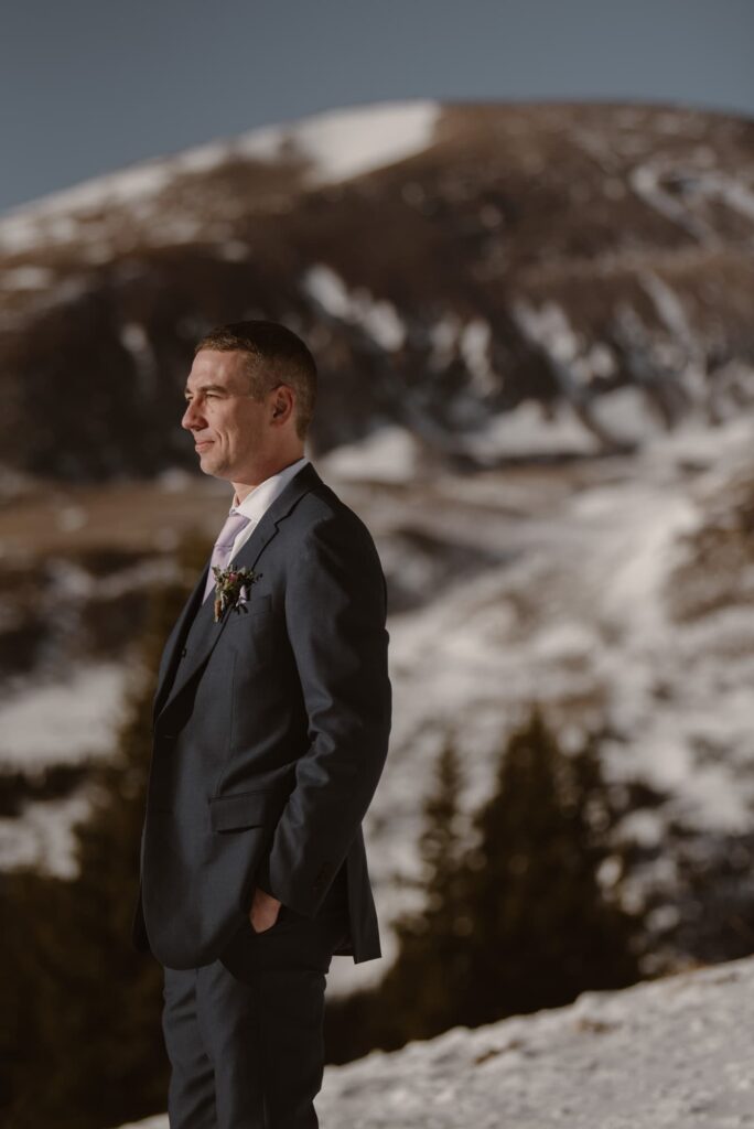 Groom looking off into the distance during Breckenridge ski elopement