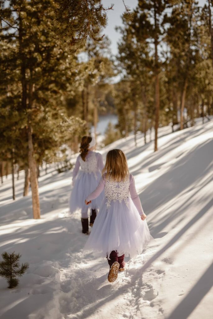 Little girls hiking down a snowy path