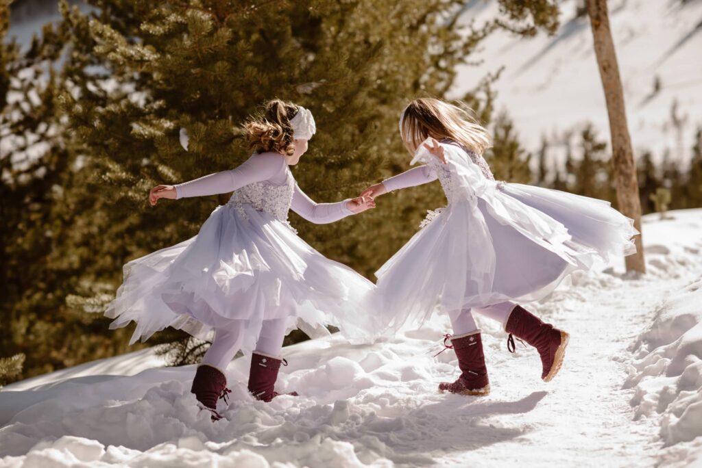 Two girls spinning in the snow