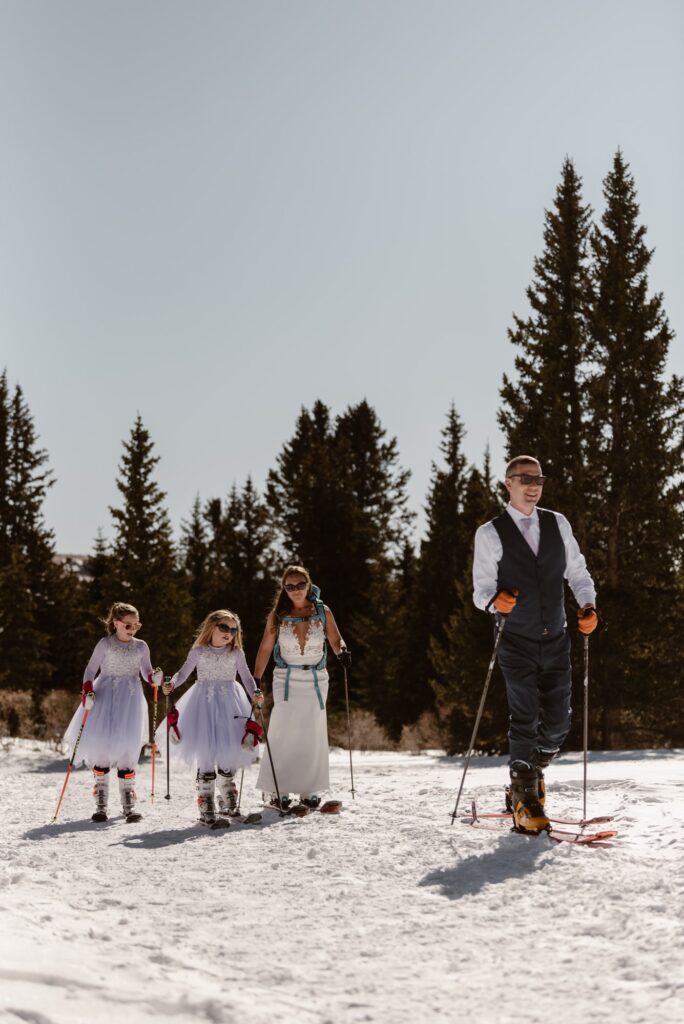 Family skiing together on their wedding day
