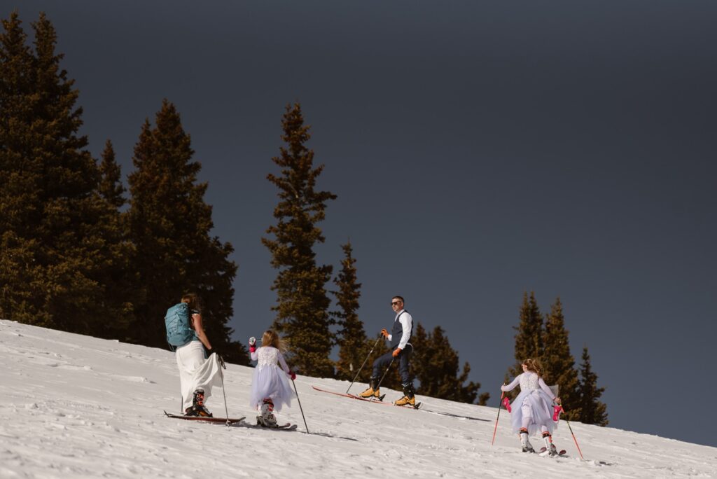 Family wedding day ski session with blue skies in Colorado
