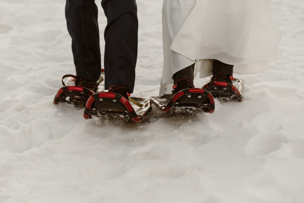 Close up of bride and groom in snowshoes