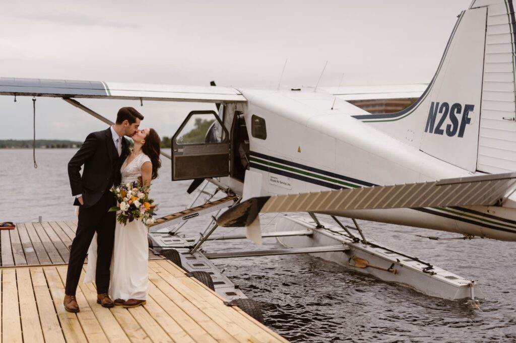 Bride and groom in front of their float plane before their elopement