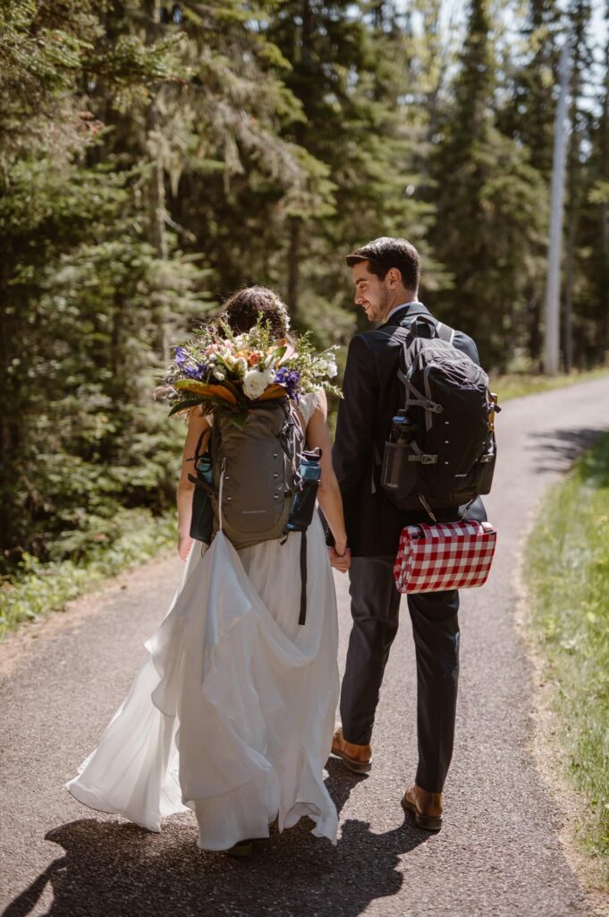 Bride and groom taking off for a hike at their National Park elopement
