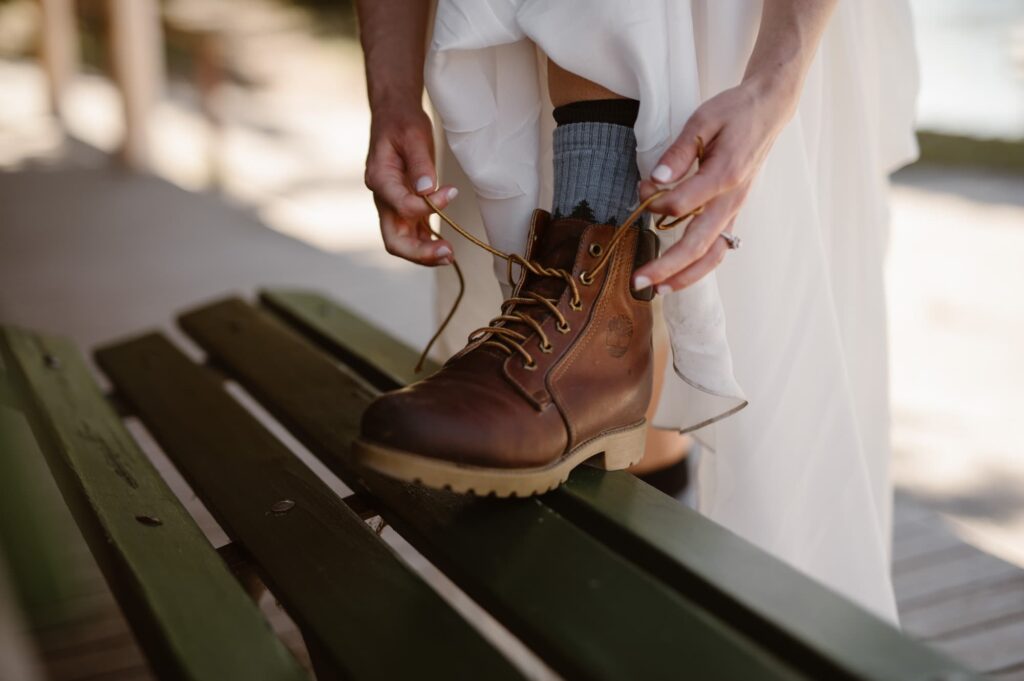 Bride tying her hiking boot before her Isle Royale National Park elopement hike
