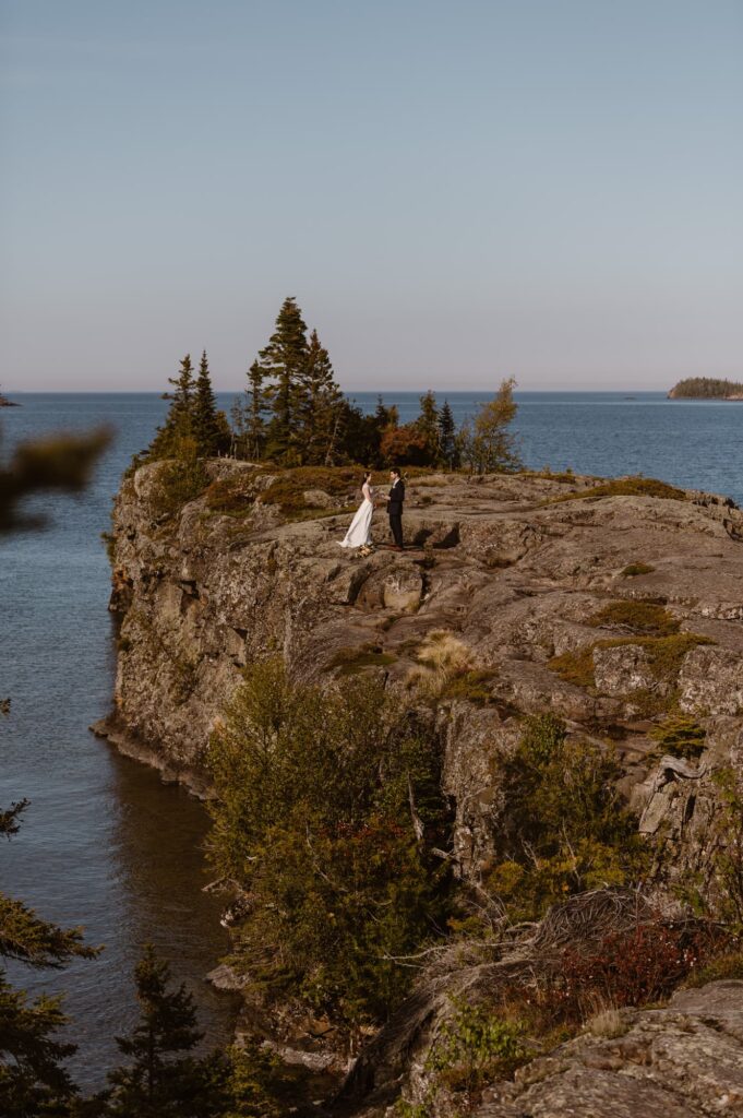 Couple getting married on rocky shoreline of Isle Royale National Park