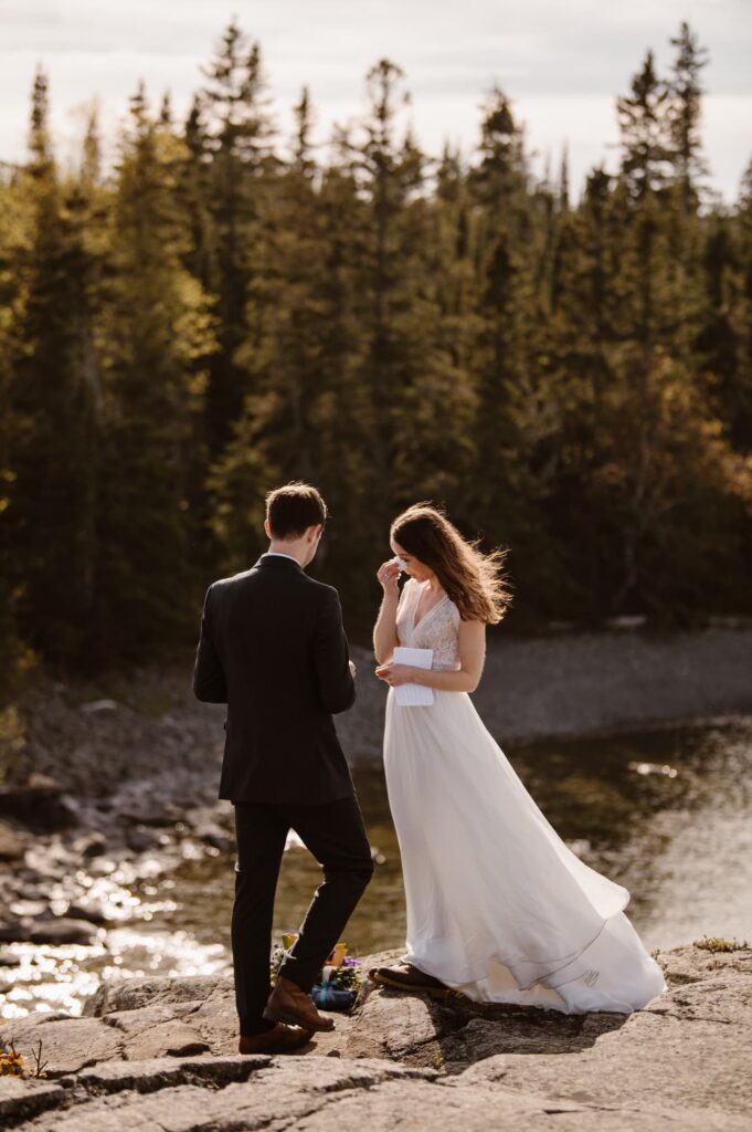 Groom reading vows at Isle Royale National Park elopement