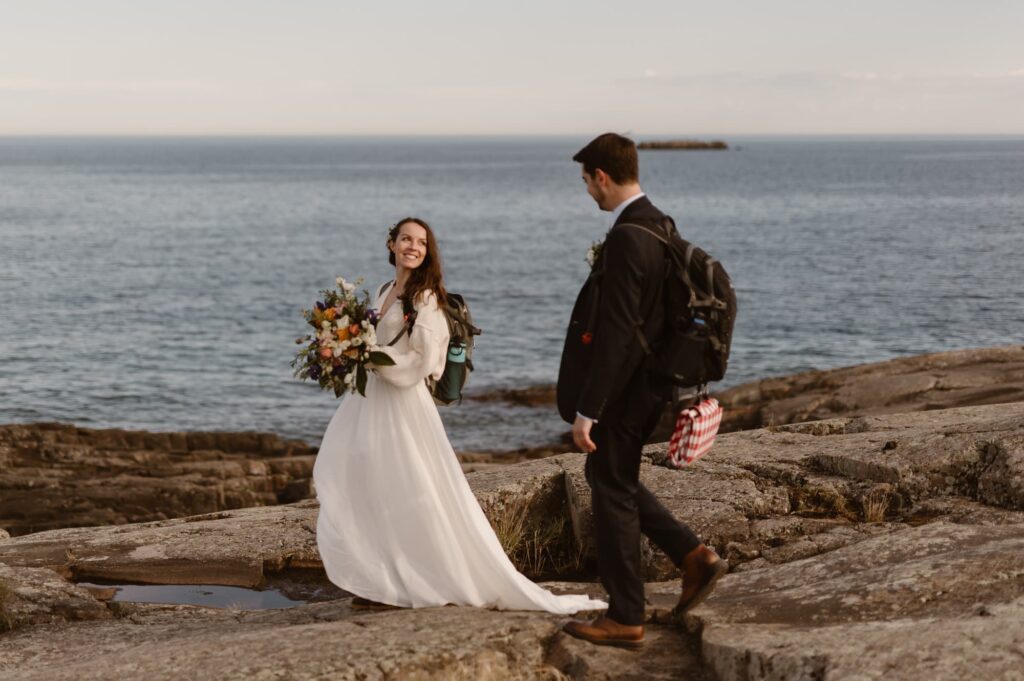 Couple walking off to find a picnic site after exchanging vows