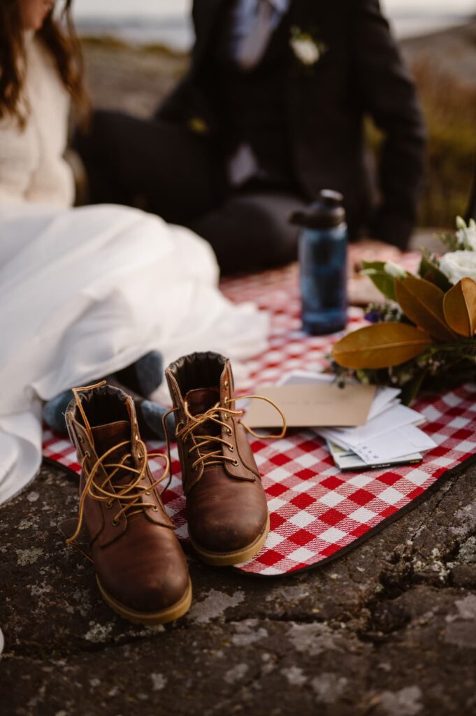 Hiking boots on the edge of a picnic blanket
