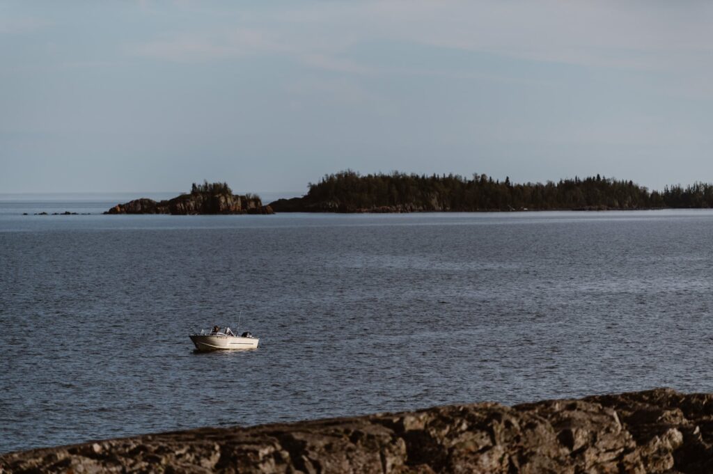 Stunning view of boat riding along the shore of Isle Royale National Park